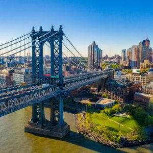 Luxury limo near Manhattan Bridge in NYC – black car service with skyline backdrop