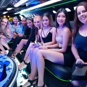 Group of young women enjoying a luxury party limo with LED lighting and premium amenities.