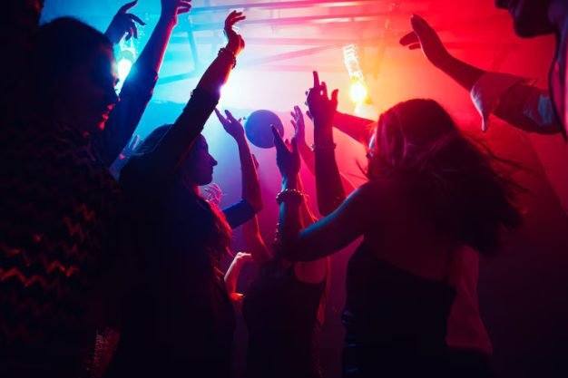 crowd-people-silhouette-raises-their-hands-dancefloor-neon-light-background-night-life-club-music-dance-motion-youth-purple-pink-colors-moving-girls-boys_489646-2750