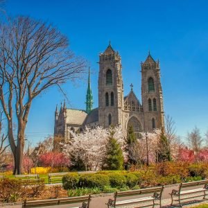 Chauffeured black limousine service in Downtown Newark NJ near city buildings